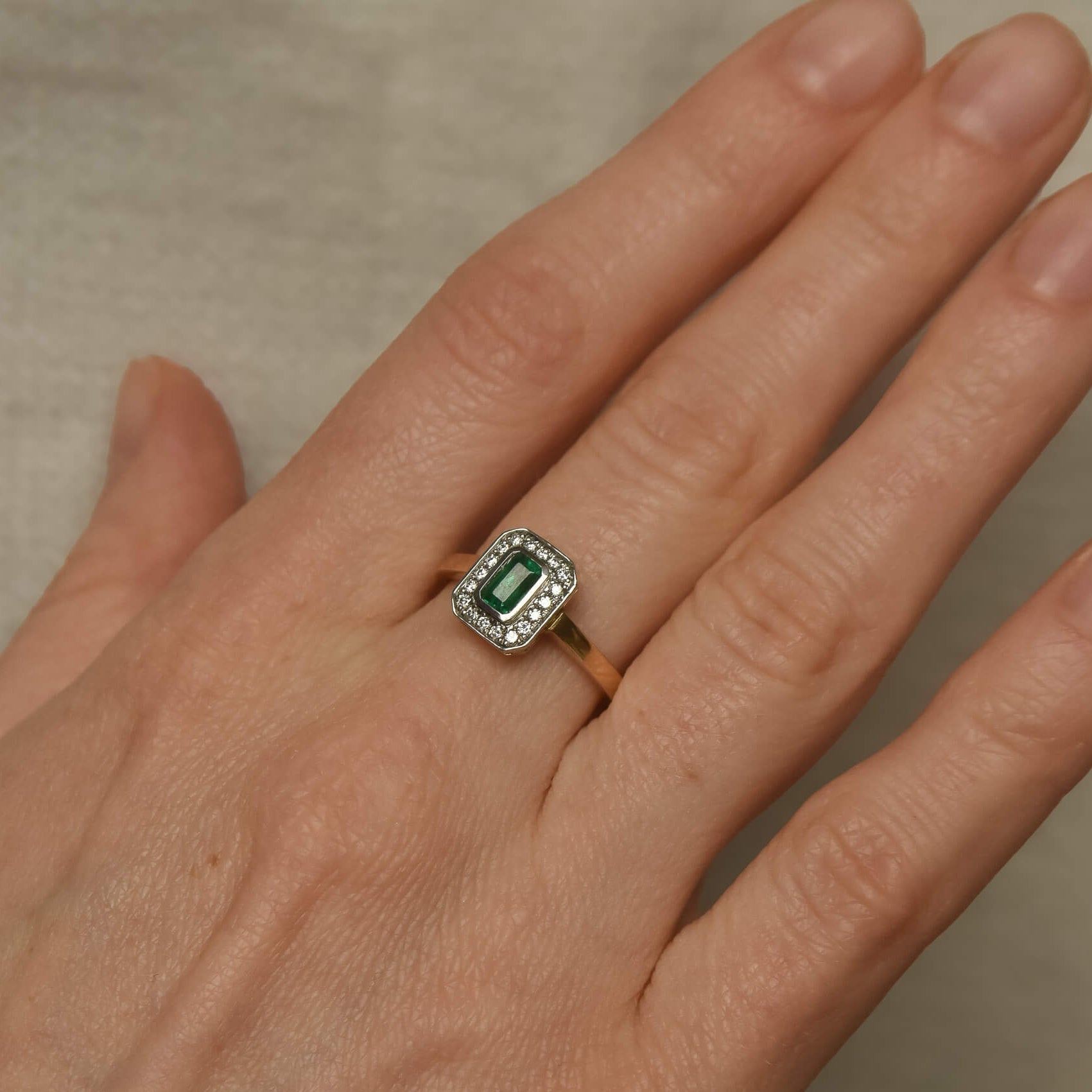Two-Tone Gold Ring with Rectangular Emerald and Diamond Halo